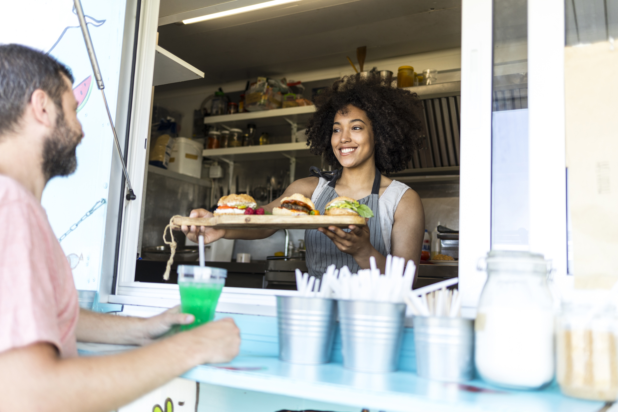 Tourist taking burgers from food van