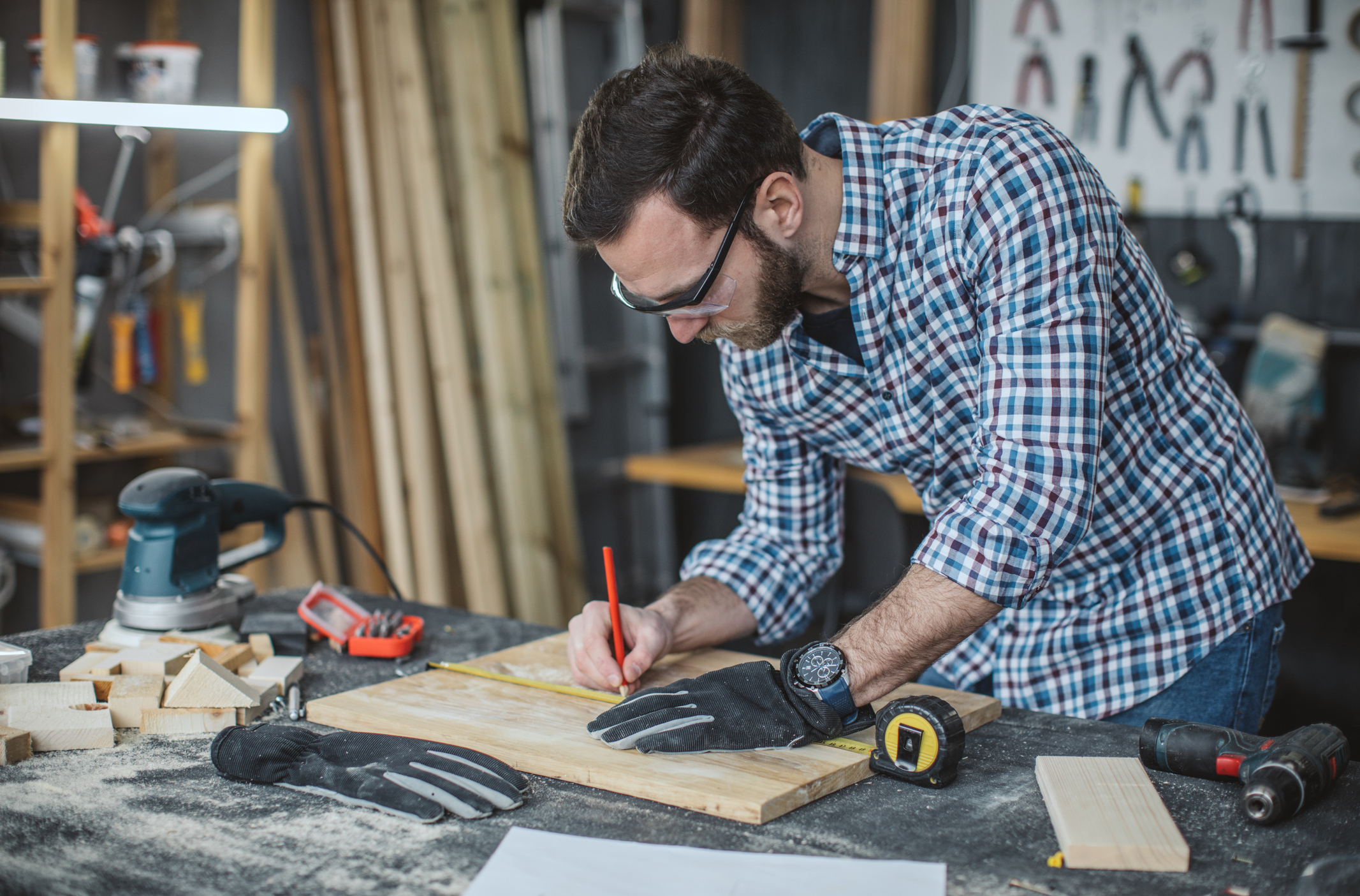 Man working on some project in carpenter workshop