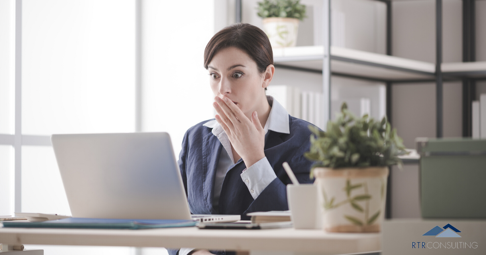 woman shocked at computer screen