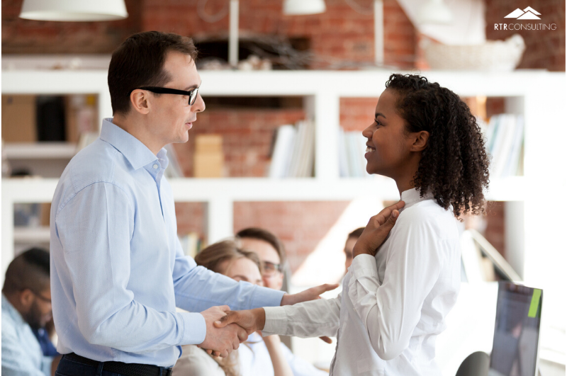 man shaking womans hand